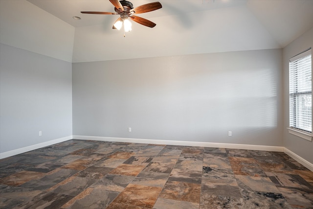 empty room featuring ceiling fan and vaulted ceiling