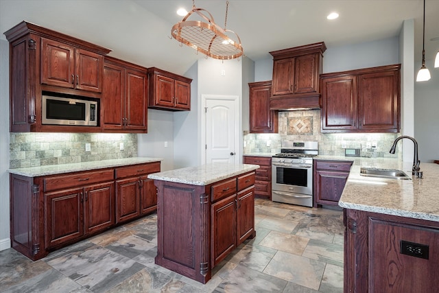 kitchen with appliances with stainless steel finishes, sink, pendant lighting, and backsplash