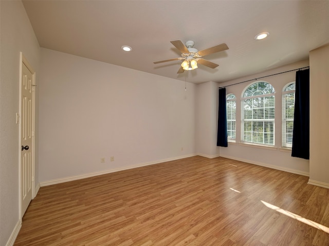 spare room with light hardwood / wood-style floors and ceiling fan