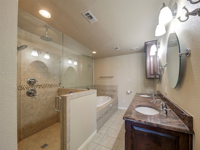 bathroom with vanity, a textured ceiling, independent shower and bath, and tile patterned floors