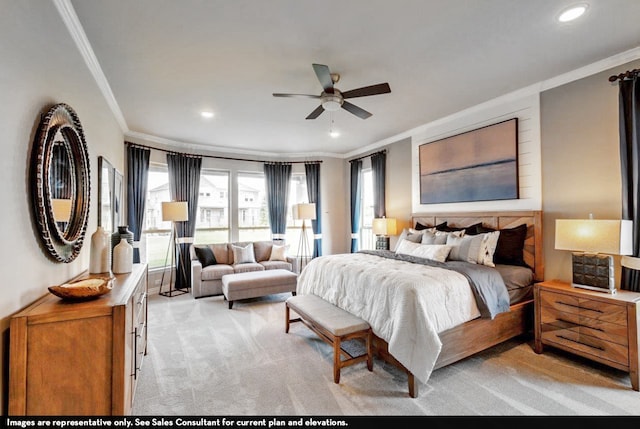 carpeted bedroom with ornamental molding and ceiling fan