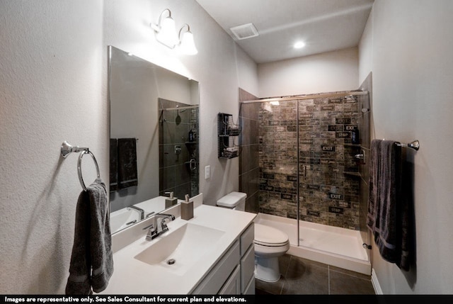 bathroom with vanity, toilet, tile patterned floors, and an enclosed shower