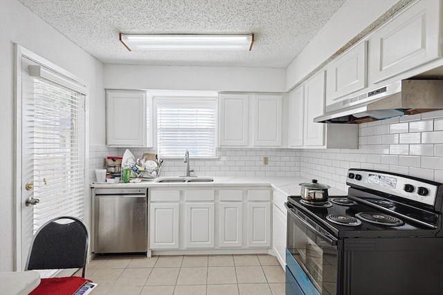 kitchen with light tile patterned flooring, white cabinetry, sink, and appliances with stainless steel finishes