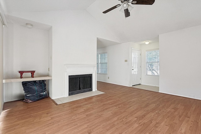 unfurnished living room featuring high vaulted ceiling, light hardwood / wood-style flooring, and ceiling fan