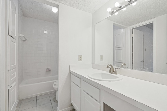 full bathroom featuring tile patterned floors, vanity, a textured ceiling, toilet, and tiled shower / bath