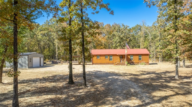 view of front of property with a garage and an outbuilding