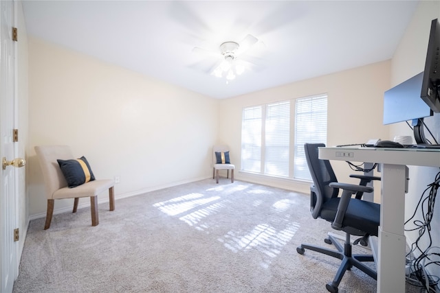 office featuring ceiling fan and light carpet