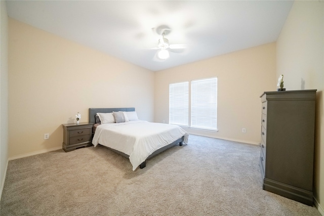 bedroom featuring light colored carpet and ceiling fan