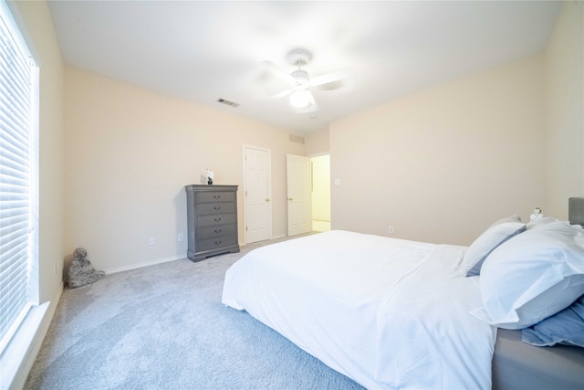 bedroom with ceiling fan and light colored carpet