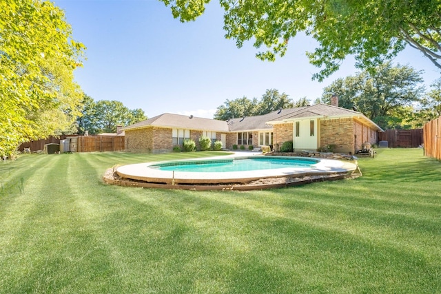 view of swimming pool with a yard and a patio