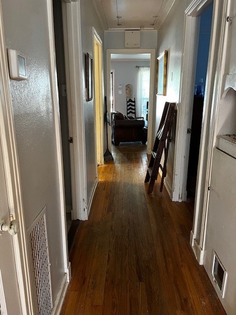 corridor with crown molding and dark hardwood / wood-style floors