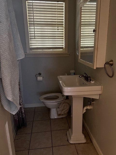 bathroom featuring toilet and tile patterned floors