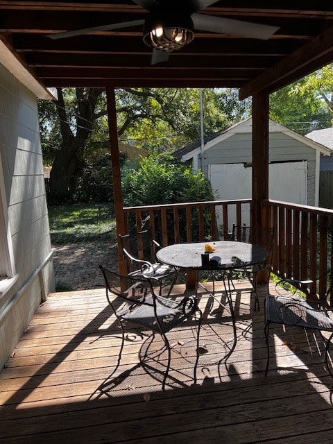 wooden terrace with a storage shed