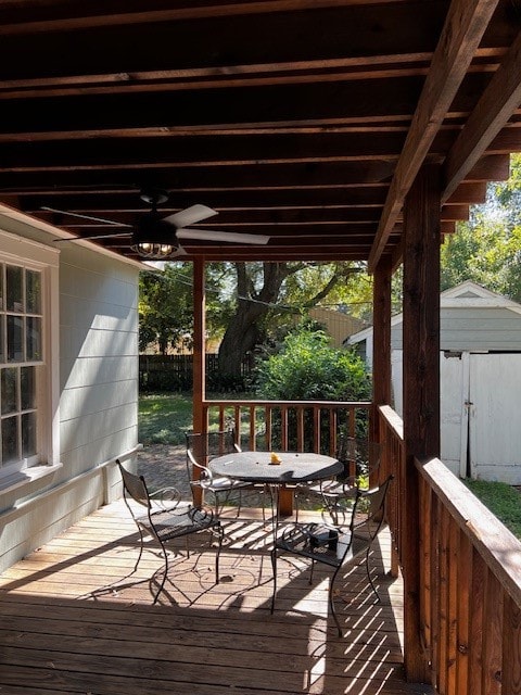 wooden terrace featuring a shed and ceiling fan