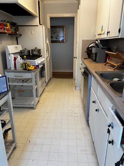 kitchen featuring dishwasher, white cabinetry, a sink, and white range with gas cooktop