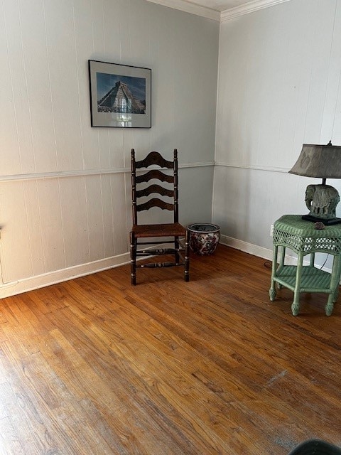 living area featuring crown molding and hardwood / wood-style floors