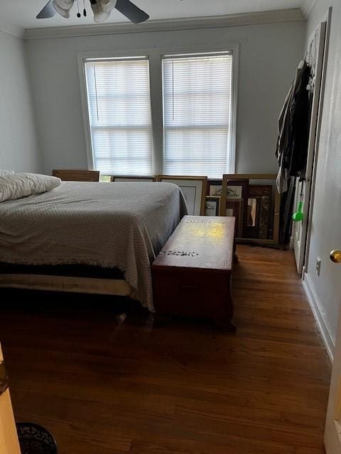 bedroom with crown molding, a ceiling fan, and wood finished floors