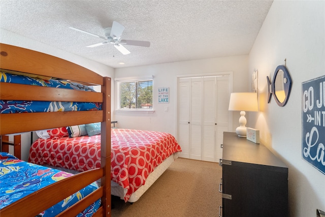 bedroom featuring a closet, a textured ceiling, carpet flooring, and ceiling fan