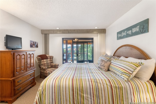 carpeted bedroom with french doors, a textured ceiling, and access to exterior