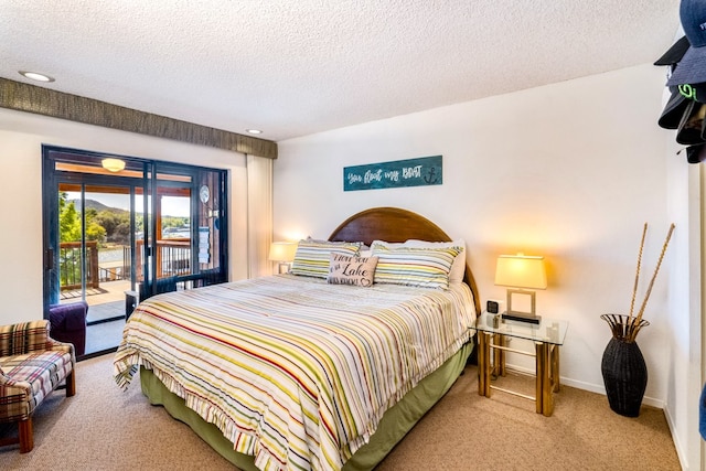 carpeted bedroom featuring a textured ceiling and access to exterior