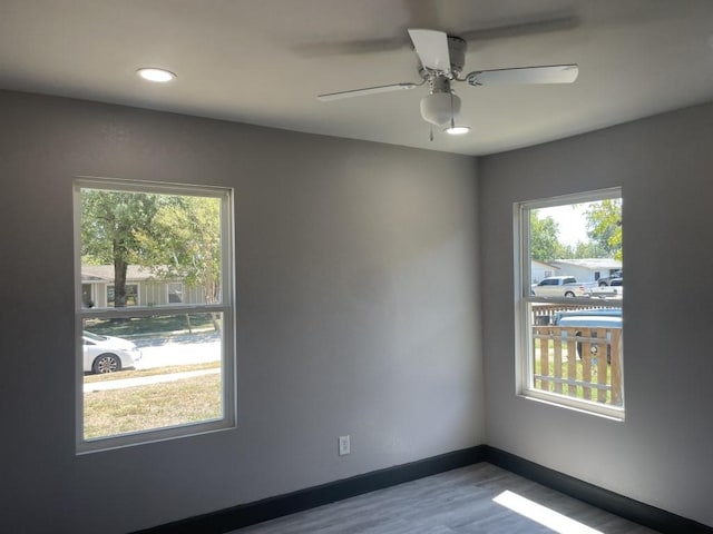 empty room with hardwood / wood-style floors and ceiling fan