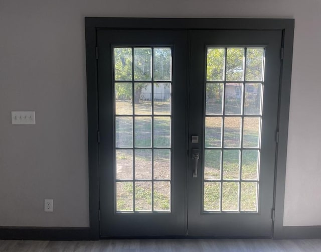 doorway to outside with light hardwood / wood-style floors and french doors