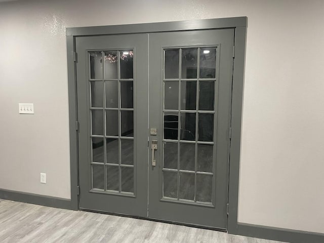 interior details featuring wood-type flooring and french doors