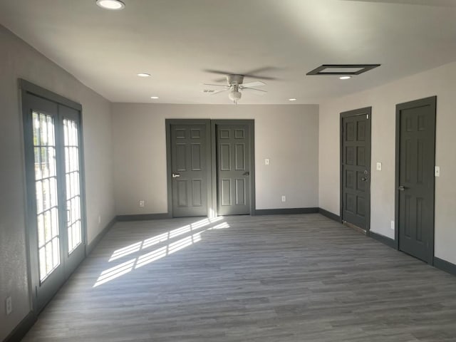 unfurnished room featuring dark hardwood / wood-style flooring, ceiling fan, and a healthy amount of sunlight