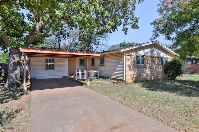 ranch-style home with a carport and a front yard