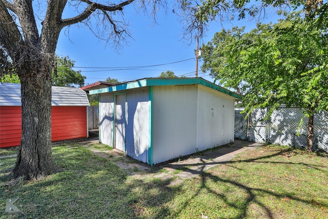 view of outbuilding featuring a lawn