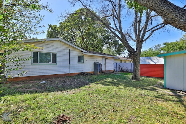 back of house featuring a yard