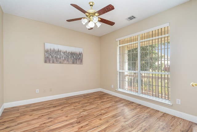 unfurnished room with ceiling fan, a healthy amount of sunlight, and light hardwood / wood-style floors