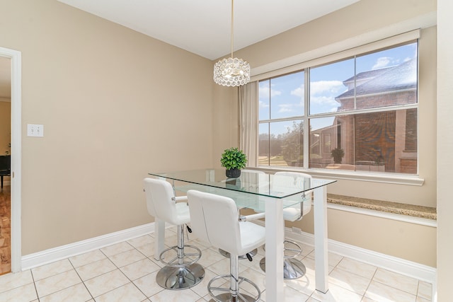 tiled dining area featuring a chandelier