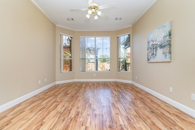 empty room featuring light wood-type flooring, ceiling fan, and crown molding