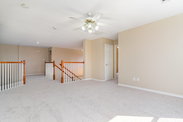 carpeted spare room with ceiling fan