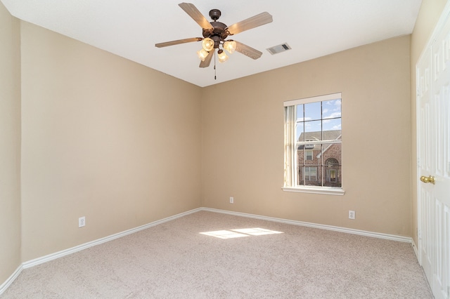 spare room featuring carpet flooring and ceiling fan