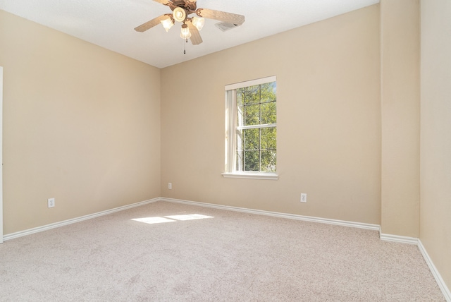 carpeted spare room featuring ceiling fan