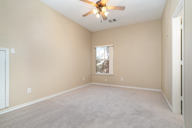 carpeted empty room featuring ceiling fan and a textured ceiling