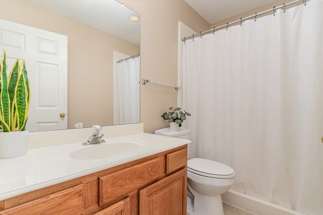 bathroom featuring vanity, a textured ceiling, and toilet