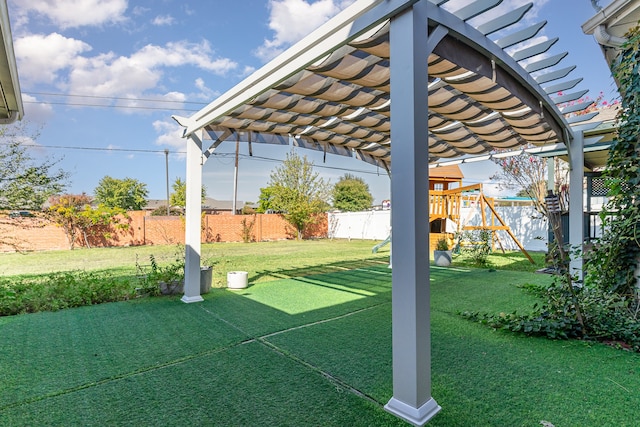 view of yard with a pergola and a playground