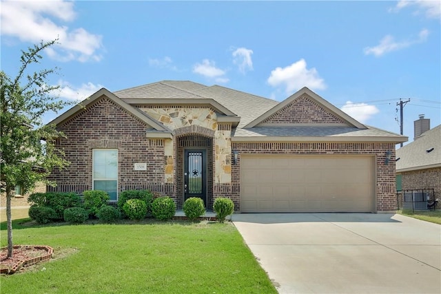 view of front of property with a front yard and a garage