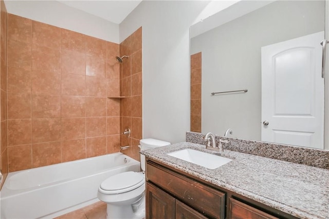 full bathroom featuring tiled shower / bath, vanity, toilet, and tile patterned flooring