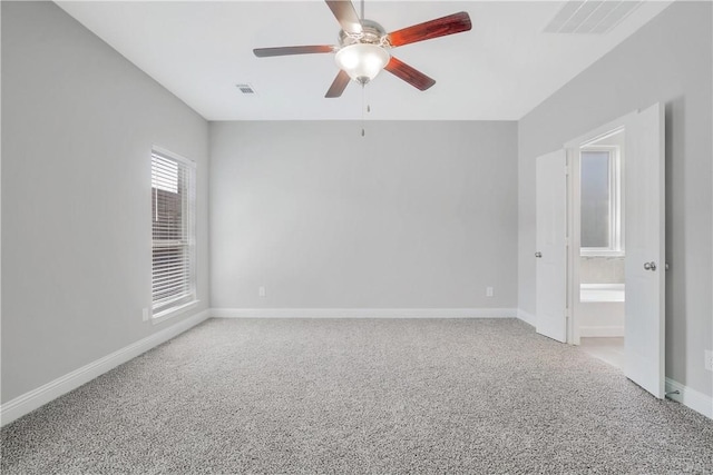 carpeted spare room with ceiling fan