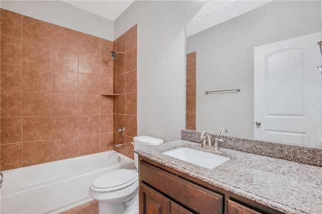 full bathroom with vanity, tiled shower / bath, and toilet