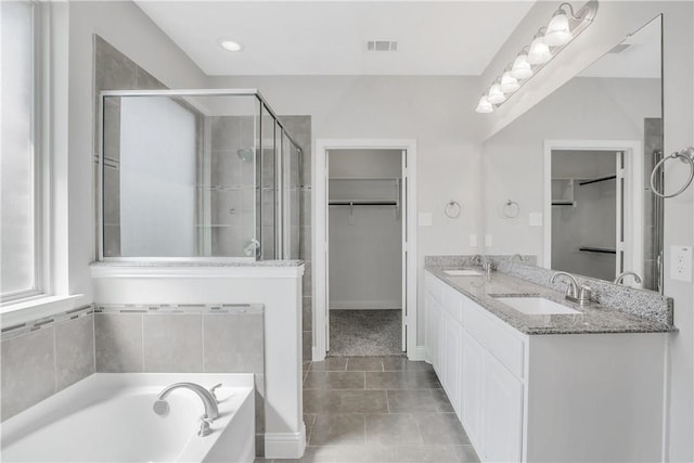 bathroom featuring vanity, shower with separate bathtub, and tile patterned flooring