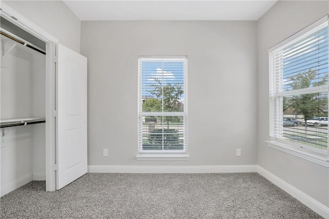 unfurnished bedroom featuring a closet and carpet flooring