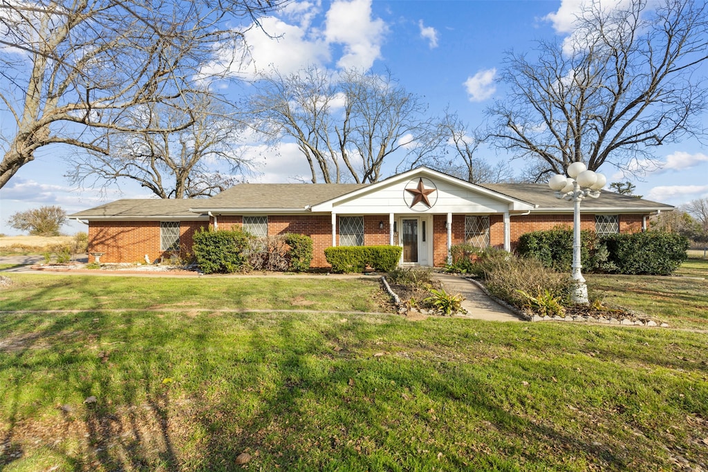 ranch-style home featuring a front yard