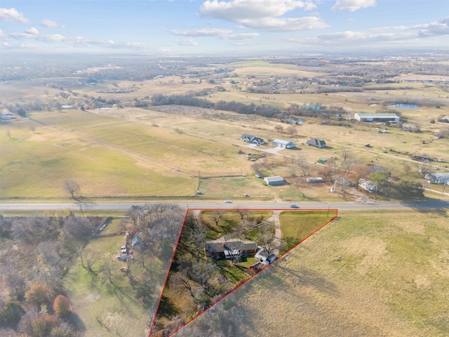 birds eye view of property with a rural view