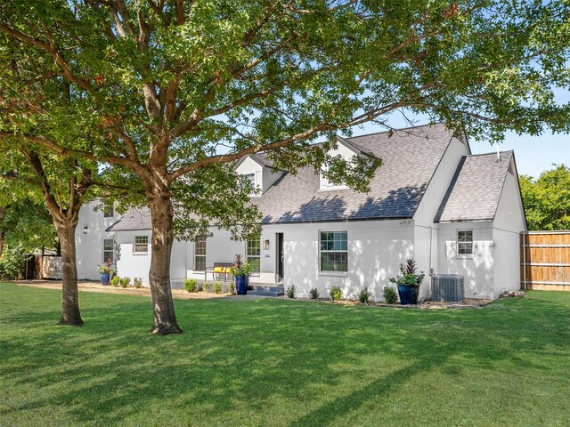 3961 Merrell Rd, Dallas, TX 75229 - back of house with a lawn, brick siding, fence, cooling unit, and a shingled roof
