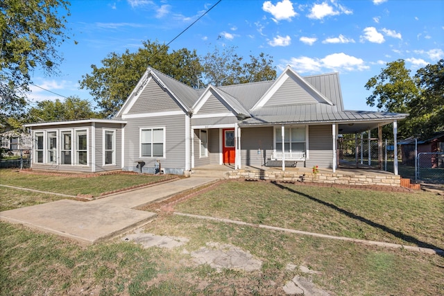 view of front of house with a front yard, a carport, and a porch